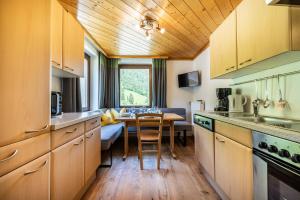 a kitchen with a table and a dining room at Appartement Angerhaus in Kleinarl