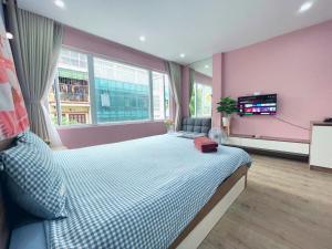 ein Schlafzimmer mit einem großen Bett und einer rosa Wand in der Unterkunft May - Street Sky View sđt 09756-59323 in Hanoi