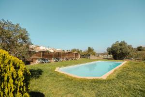 a swimming pool in the yard of a house at Aldeia da Pedralva by WOT Signature in Vila do Bispo