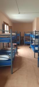 a room with several bunk beds in a room at El Camino de las Estrellas in Navarrete