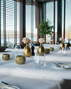 a long table with vases and flowers on it at Valuas in Venlo