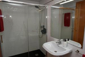 a bathroom with a sink and a glass shower at Ancla Spaces EGVT-436-CS no vista al mar in Vinaròs