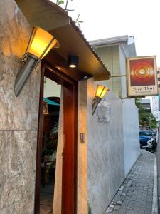 a couple of lights on the side of a building at Sala Boutique Hotel in Male City
