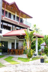 a house with a table and chairs in front of it at Shan Star Weligama in Weligama