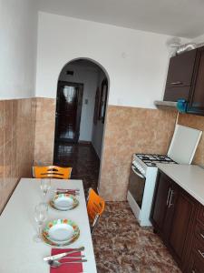 a kitchen with a table with a plate on it at APARTAMENT HD ELI in Hunedoara