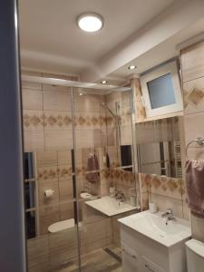 a bathroom with two sinks and a mirror at APARTAMENT HD ELI in Hunedoara