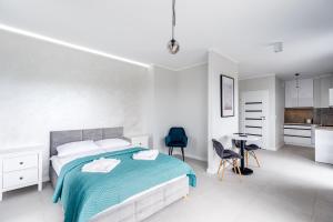 Łóżko lub łóżka w pokoju w obiekcie Balticus Apartamenty Standard Promenada Gwiazd 14