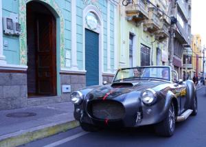 an old car parked on a city street at Casa 1881 in Riobamba