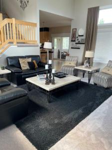 a living room with a couch and a table at Lakeville Executive Home with every amenity, prime location in Lakeville