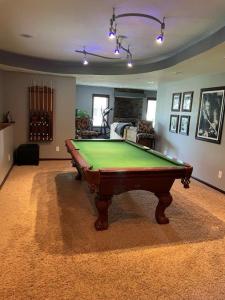 a living room with a pool table in it at Lakeville Executive Home with every amenity, prime location in Lakeville