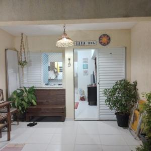 a door leading into a room with a chandelier at Recanto Casa SOL in Barra de Jacuípe