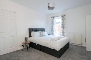 a bedroom with a large bed and a window at Frederick House in Brandon