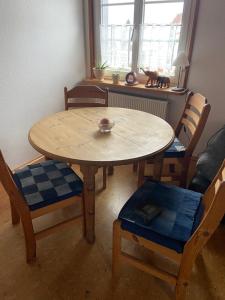 a dining room table with chairs and a bowl on it at Haus Bergblick in Kißlegg