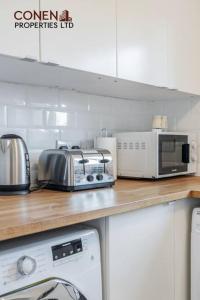 a kitchen with a counter top with appliances on it at CONEN Chafford Three Apartment in West Thurrock