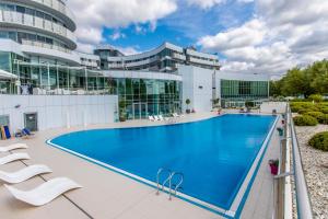 a large swimming pool on the roof of a building at Copernicus Toruń Hotel in Toruń