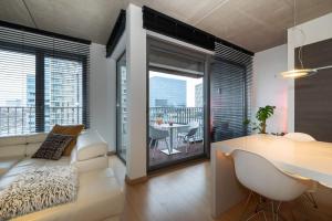a living room with a couch and a table with a view at London 993 Loft 402 in Antwerp
