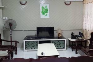 a living room with a desk with a laptop computer on it at J & I Homestay in Sibu