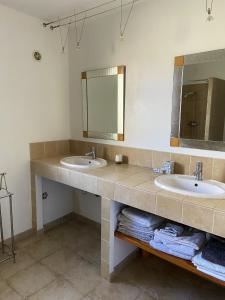 a bathroom with two sinks and a mirror and towels at Appartement moderne à Saint-Florent, 70 m², terrasse in Saint-Florent