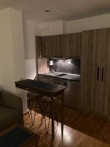 a kitchen with a table and a counter top at Apartman Jelka Brzece in Brzeće