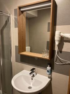 a bathroom with a sink and a mirror at Apartman Jelka Brzece in Brzeće