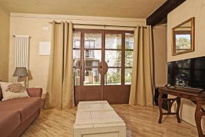 a living room with a couch and a piano at Dogoli Country Apartments in Bardolino