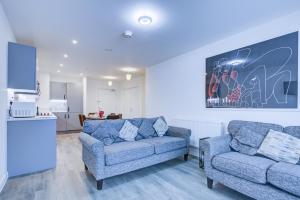a living room with two chairs and a couch at 2 bed 2 bath Modern Apartment in East Acton in London
