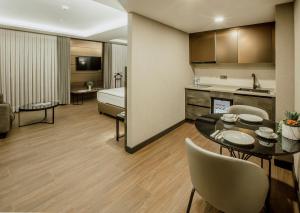a room with a bed and a table and chairs at Kızılkaya Business Otel in Korfez +19 photos