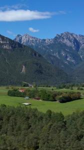 a large green field with mountains in the background at Pradileva in Tramonti di Sotto