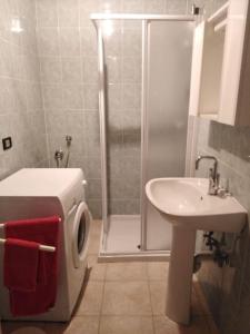 a bathroom with a shower and a toilet and a sink at Casa vacanza Miralago in Antronapiana