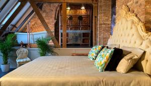 a bedroom with a large bed with pillows on it at Walburgis Residenties in Arnhem +45 photos