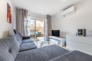 salon z kanapą i telewizorem w obiekcie Apartament Claro w mieście Torrevieja