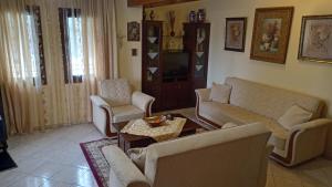 a living room with couches and a coffee table at VILLA MALILA in Panagia