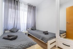 Łóżko lub łóżka w pokoju w obiekcie Apartament Claro