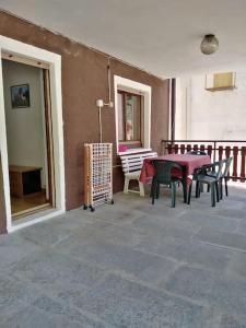 a patio with a table and chairs next to a building at Millefiori house in Antronapiana