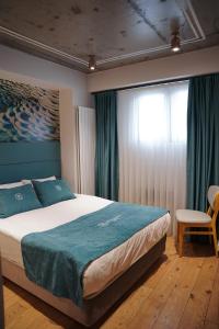 a bedroom with a large bed and a window at Royal Galata Hotel in Istanbul