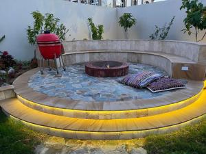 a fire pit in a backyard with a fire hydrant at Casa Shakhbout in Abu Dhabi