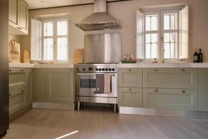 a kitchen with a stove top oven in a kitchen at CASA OTTO @ BELVEDERE PANORAMIC VIEW POINT in La Morra