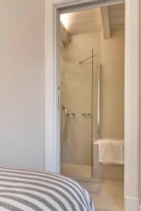 a bathroom with a shower and a bed in a room at CASA OTTO @ BELVEDERE PANORAMIC VIEW POINT in La Morra +37 photos
