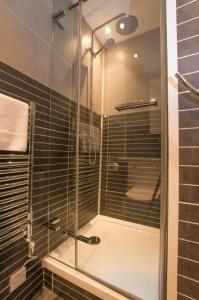 a shower with a glass door in a bathroom at Harbour Master in Kilmelfort