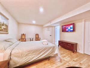 um quarto com uma cama e uma televisão na parede em Cozy Detached Home in Richmond Hill em Richmond Hill