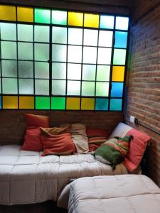 a room with two beds and a stained glass window at Loft El Taller - Rústico, elegante, acogedor in Yerba Buena