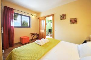 ein Schlafzimmer mit einem Bett, auf dem zwei Handtücher liegen in der Unterkunft Villa Casa Bianca Orange Apartment in Bogdanátika + 28 Fotos