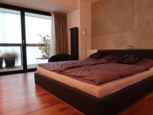 a large bed in a room with a large window at Michal apartment 125m2 city centre in Prague