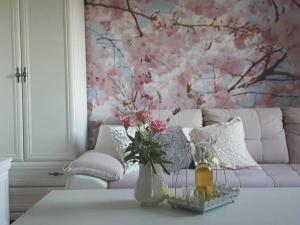 salon z kanapą i stołem z kwiatami w obiekcie Holiday Home Mali Anđeo w mieście Suza