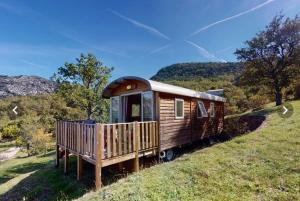 a wooden train car sitting on top of a hill at Campasun Camping de l'Aigle in Aiguines