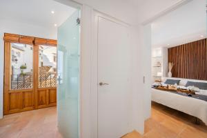 a bedroom with a glass door leading to a bed at Porta Nova Suites Altea - Adults Only in Altea