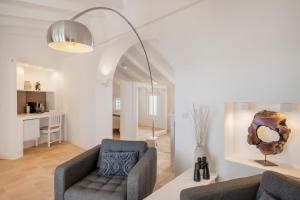 a living room with a couch and a chair at Porta Nova Suites Altea - Adults Only in Altea