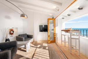 a living room with a view of the ocean at Porta Nova Suites Altea - Adults Only in Altea