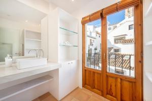 a bathroom with a sink and a window at Porta Nova Suites Altea - Adults Only in Altea