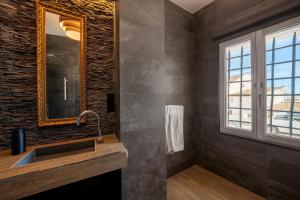 a bathroom with a sink and a mirror and a window at Porta Nova Suites Altea - Adults Only in Altea
